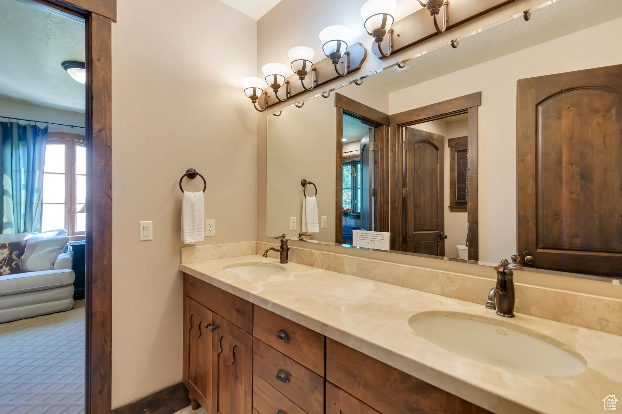 Bathroom featuring double vanity and ensuite bathroom