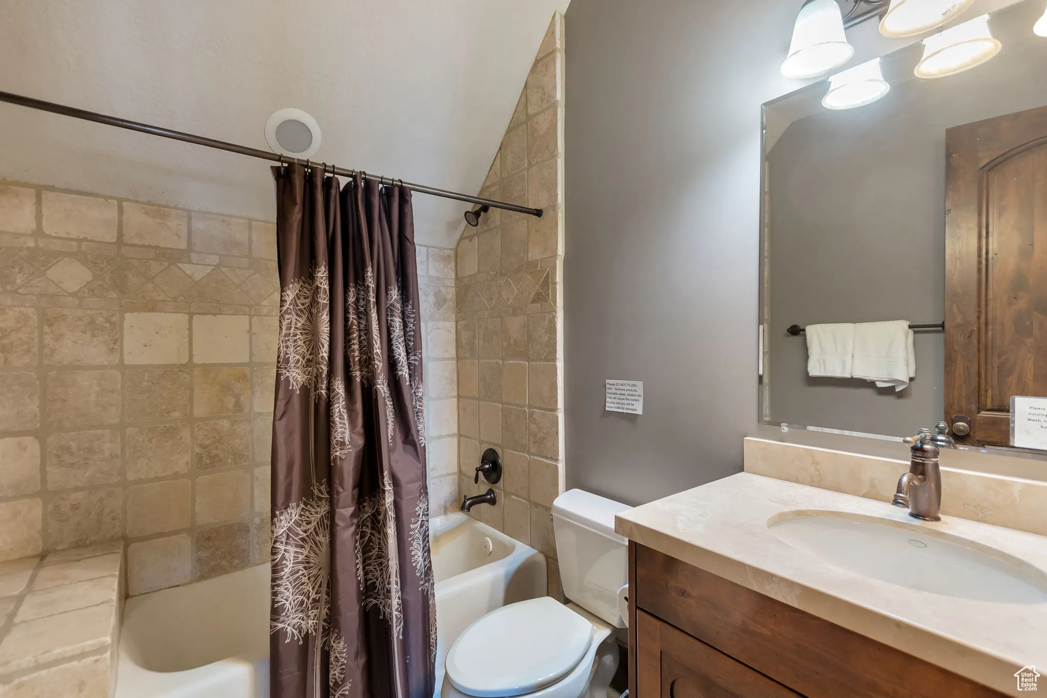 Full bathroom featuring shower / tub combo and vanity