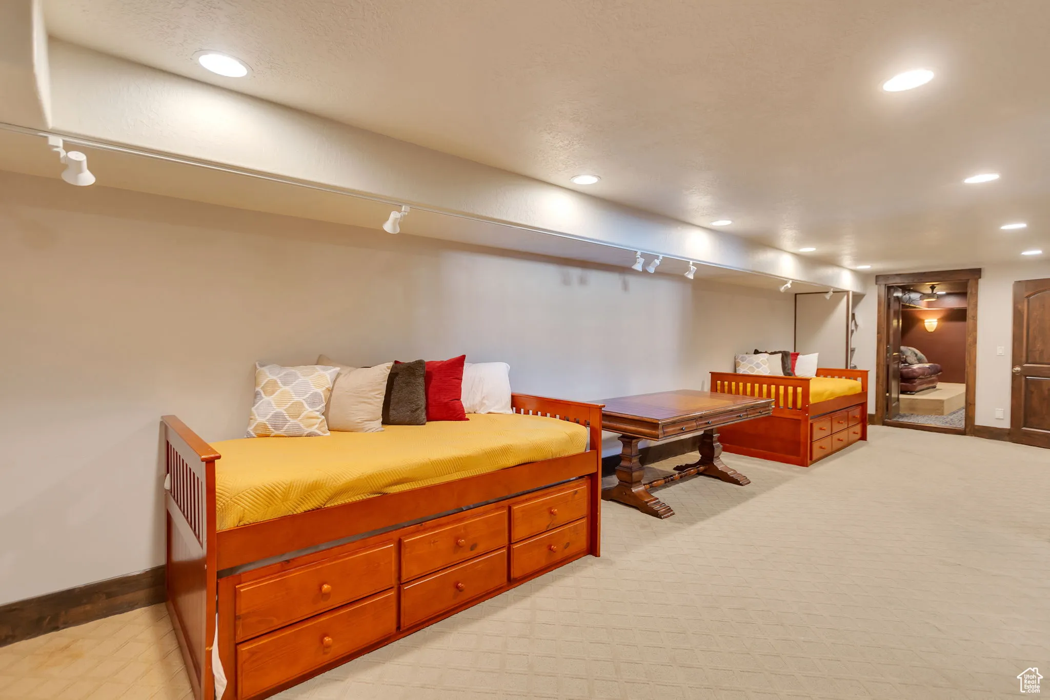 Family room/Bedroom with recessed lighting, light carpet, and track lighting