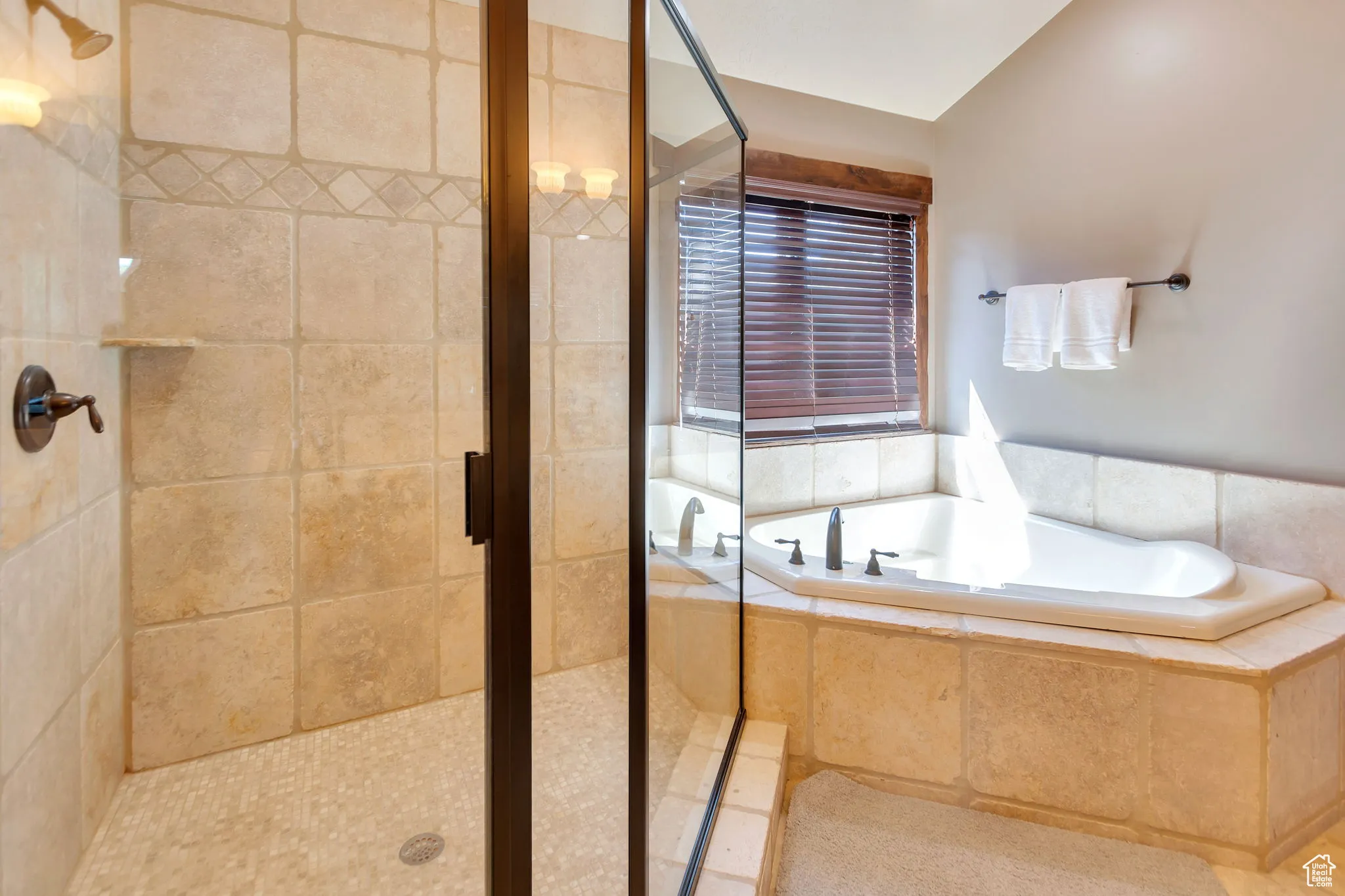 Bathroom featuring a stall shower and a garden tub