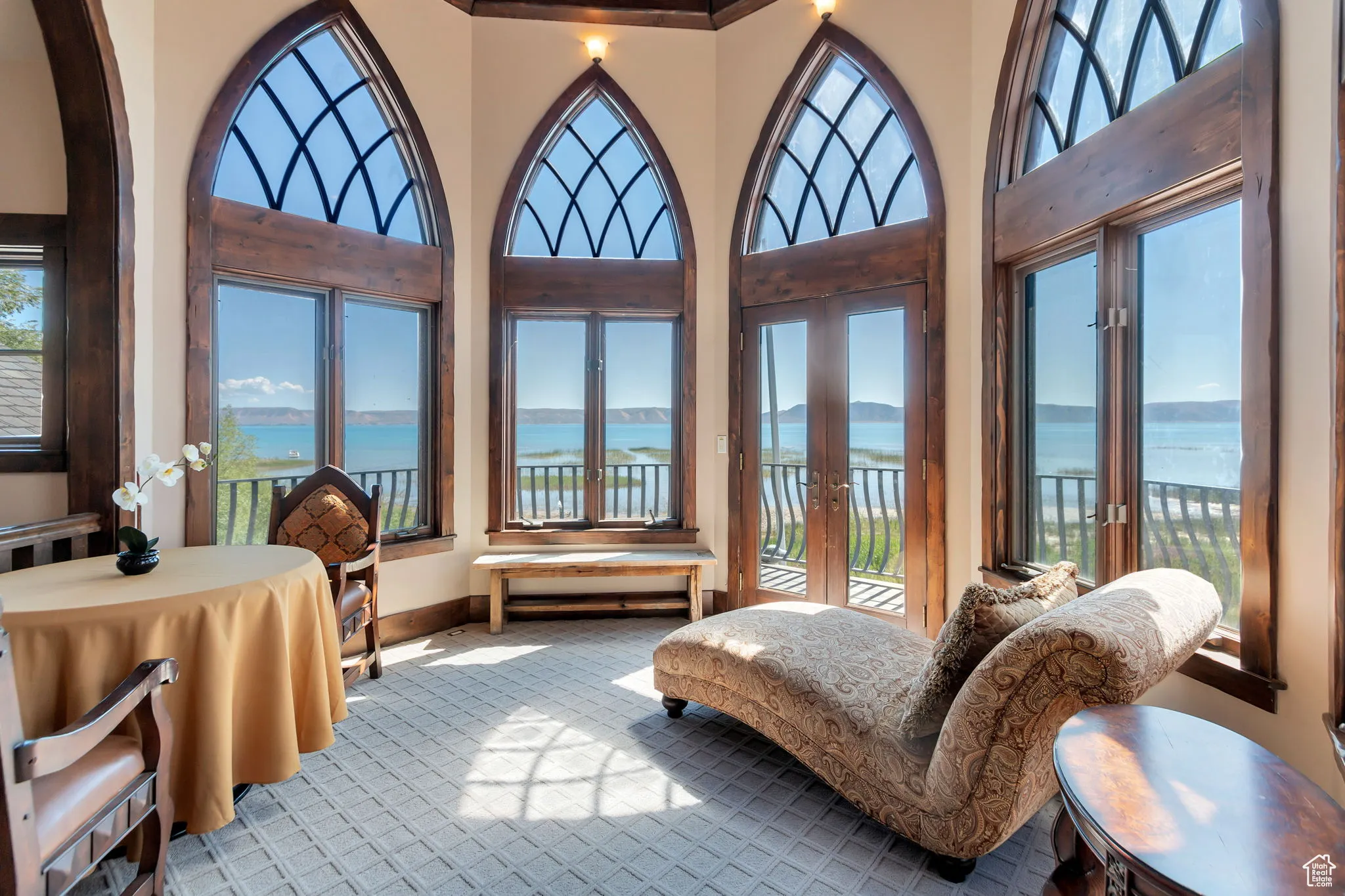 Turret featuring French doors and a water view