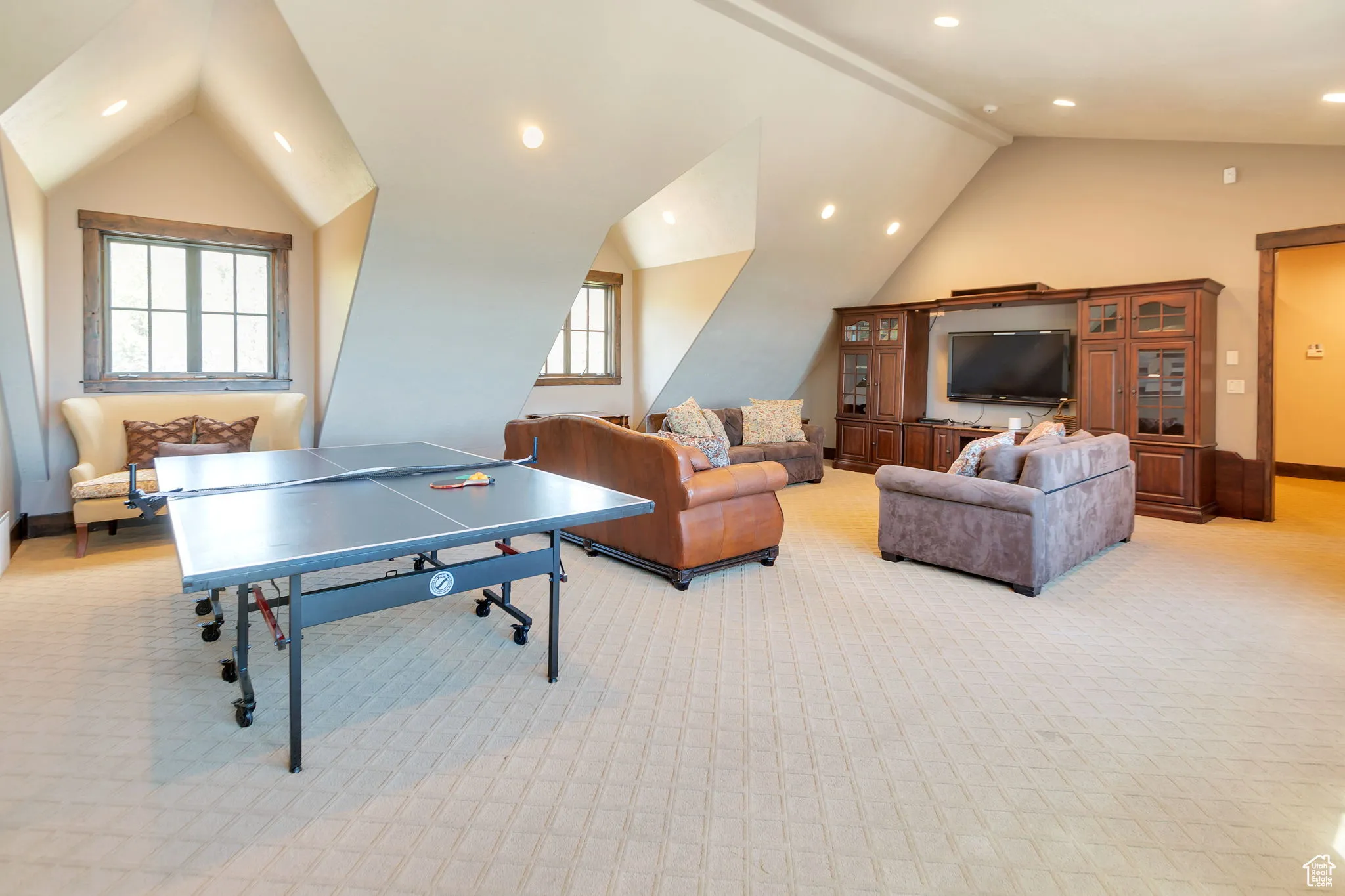 Game room with recessed lighting, light carpet, and high vaulted ceiling