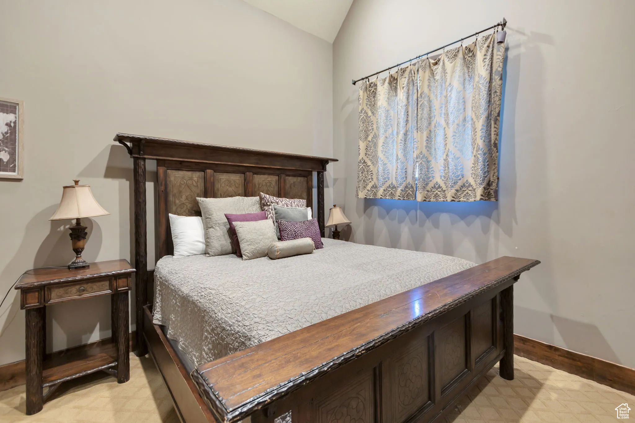 Bedroom with baseboards and lofted ceiling