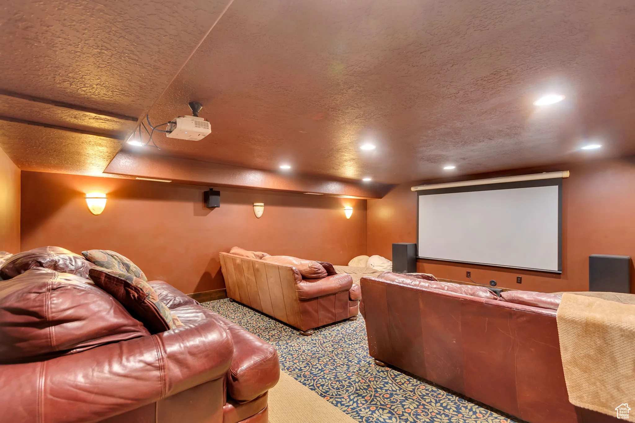 Home Theater room with a textured ceiling and carpet