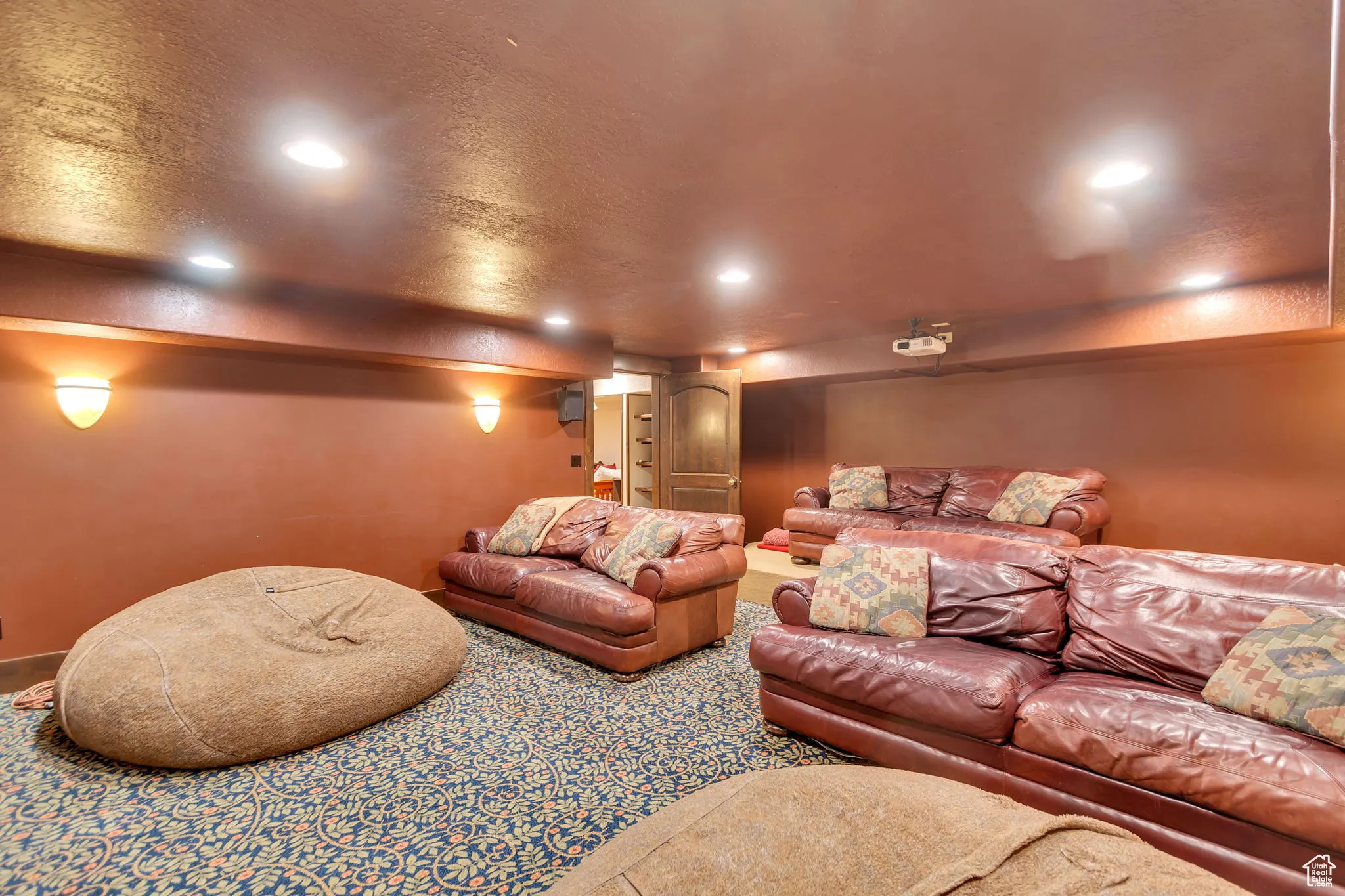 Home theater room with a textured ceiling and recessed lighting