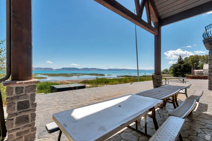 View of patio featuring a water and mountain view