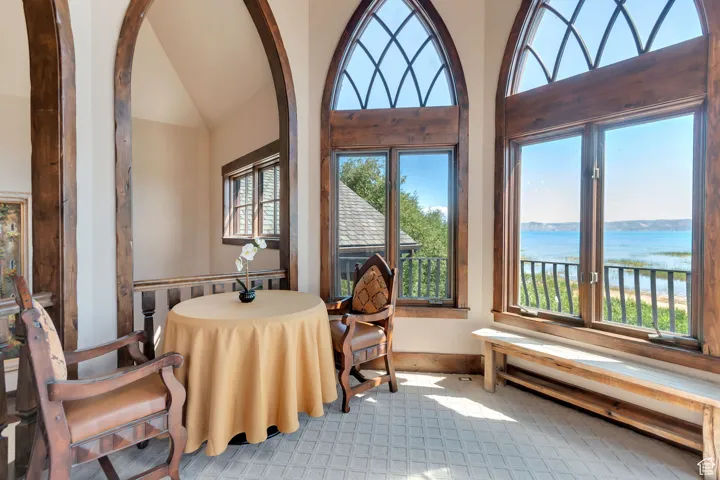 Dining room featuring a water view and high vaulted ceiling
