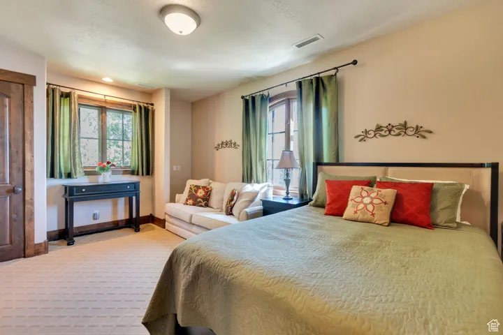 Carpeted bedroom featuring baseboards