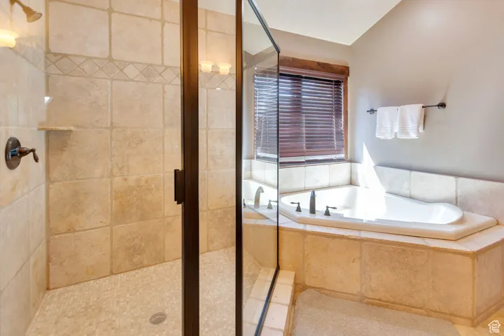 Bathroom featuring a stall shower and a garden tub