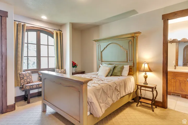 Bedroom featuring connected Jack n Jill bathroom and light tile patterned floors