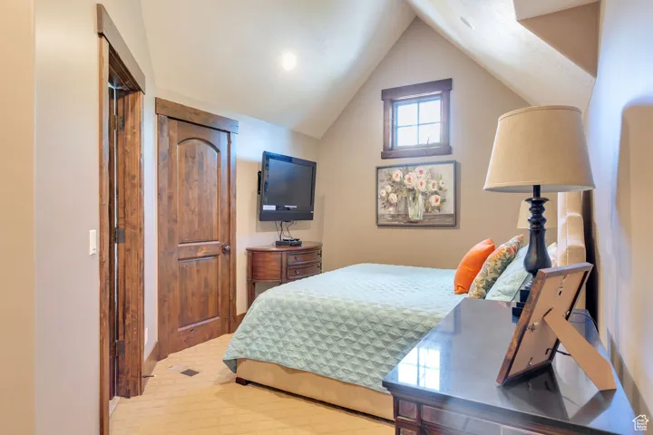 Bedroom with vaulted ceiling