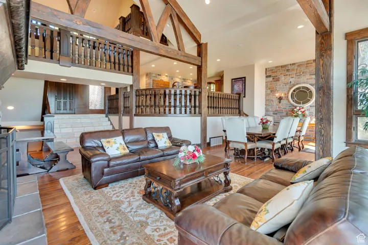 Living area featuring recessed lighting, hardwood / wood-style flooring, and a towering ceiling
