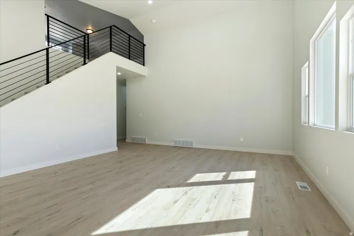 Large Great Room and Stairs up to Bonus Room.  Beautiful Modern Railing.