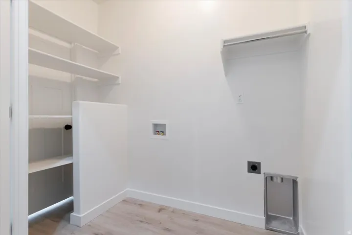 Laundry Room With Electric Dryer Hook-up and Storage Space.