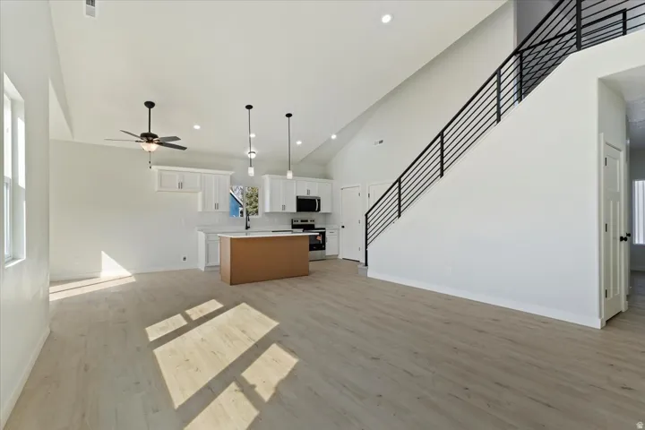 Great Room Looking Towards Kitchen and Stairway Up to Bonus Room.