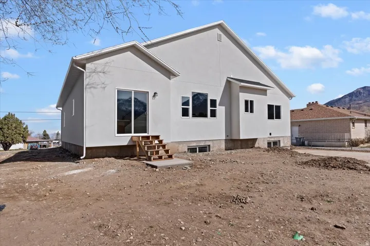 Backyard View with Large Cement Patio or Sport Area.