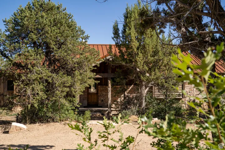 View of front of home featuring stone siding, a metal roof, and a standing seam roof