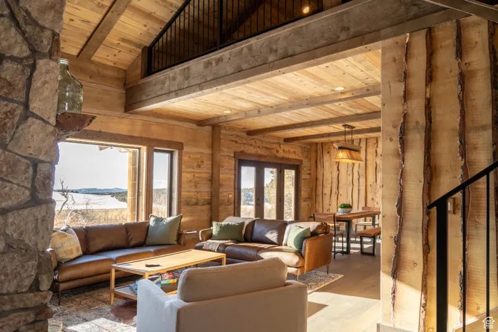 Living area featuring a wooden ceiling with exposed beams, french doors, and wood finished floors