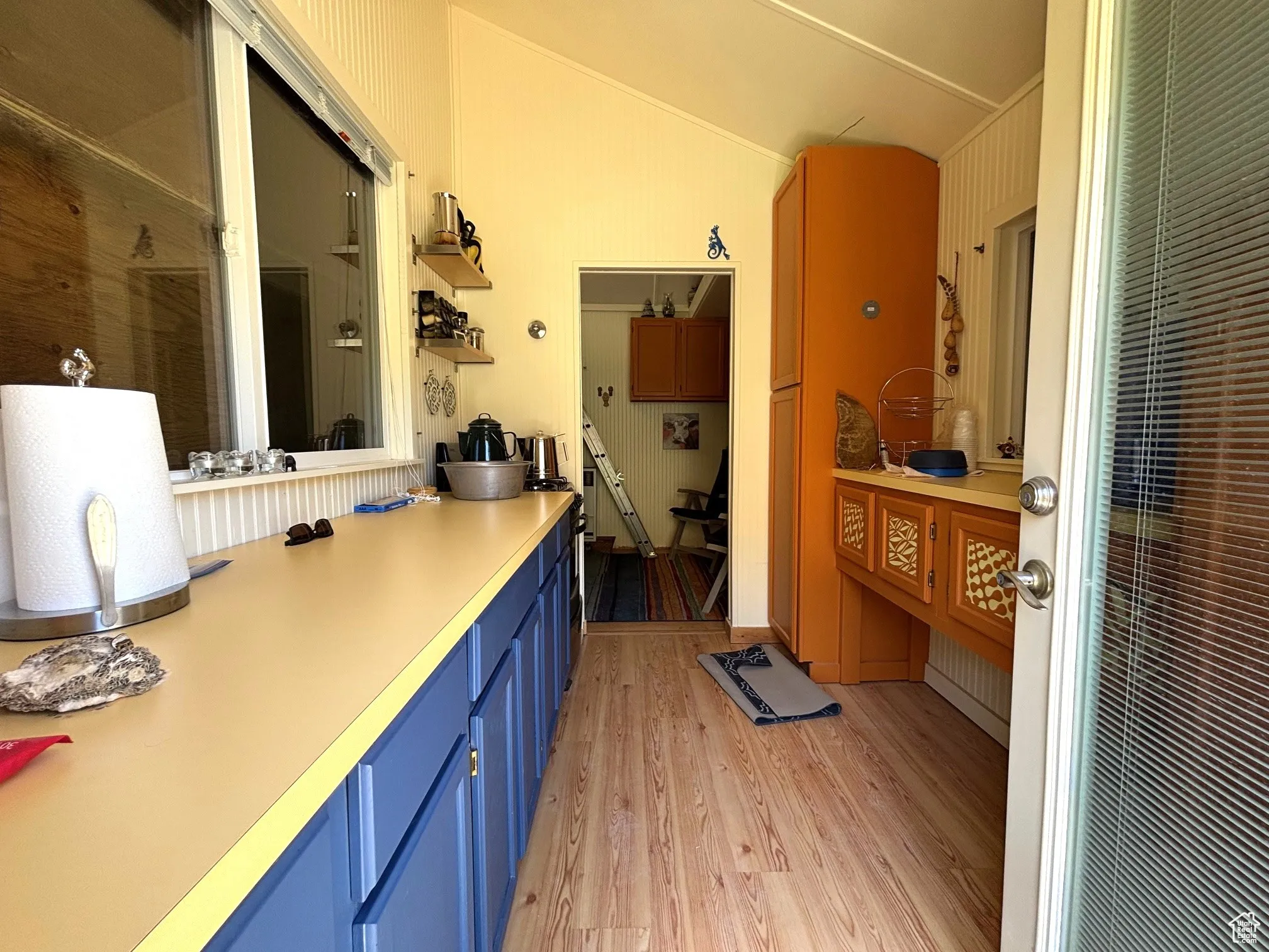 Bathroom with light wood-style floors and vaulted ceiling