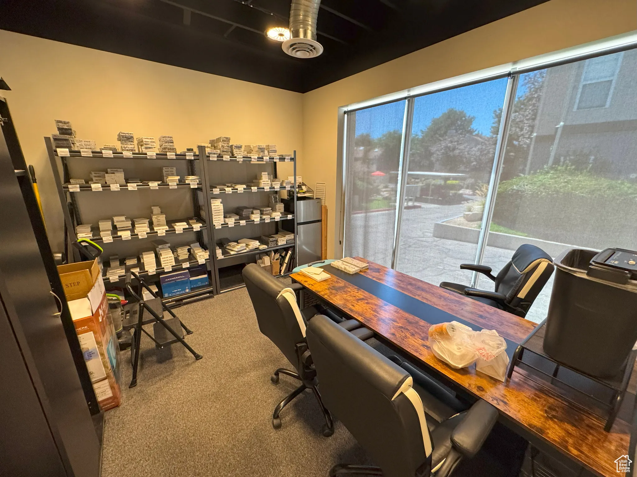 Office area featuring light carpet