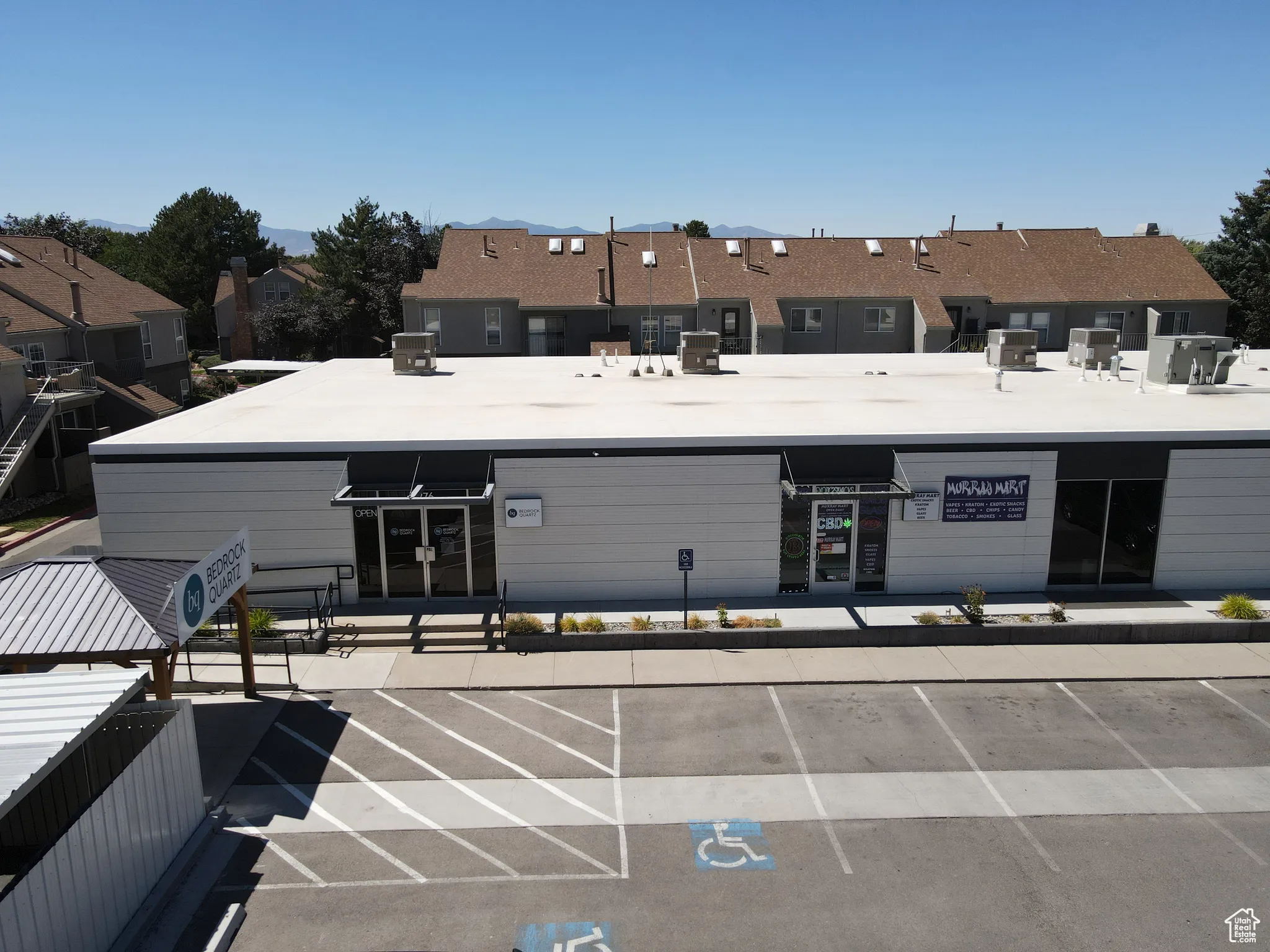 View of property featuring uncovered parking