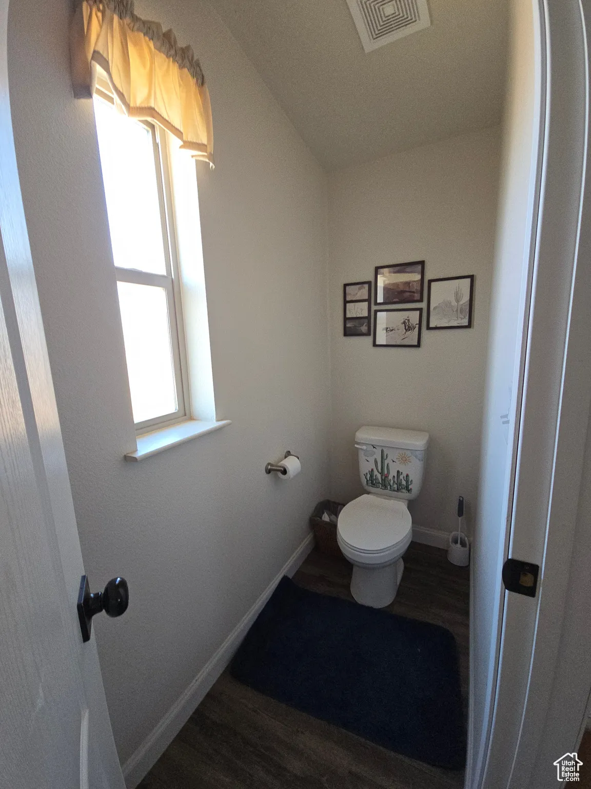 Bathroom with dark wood finished floors and baseboards