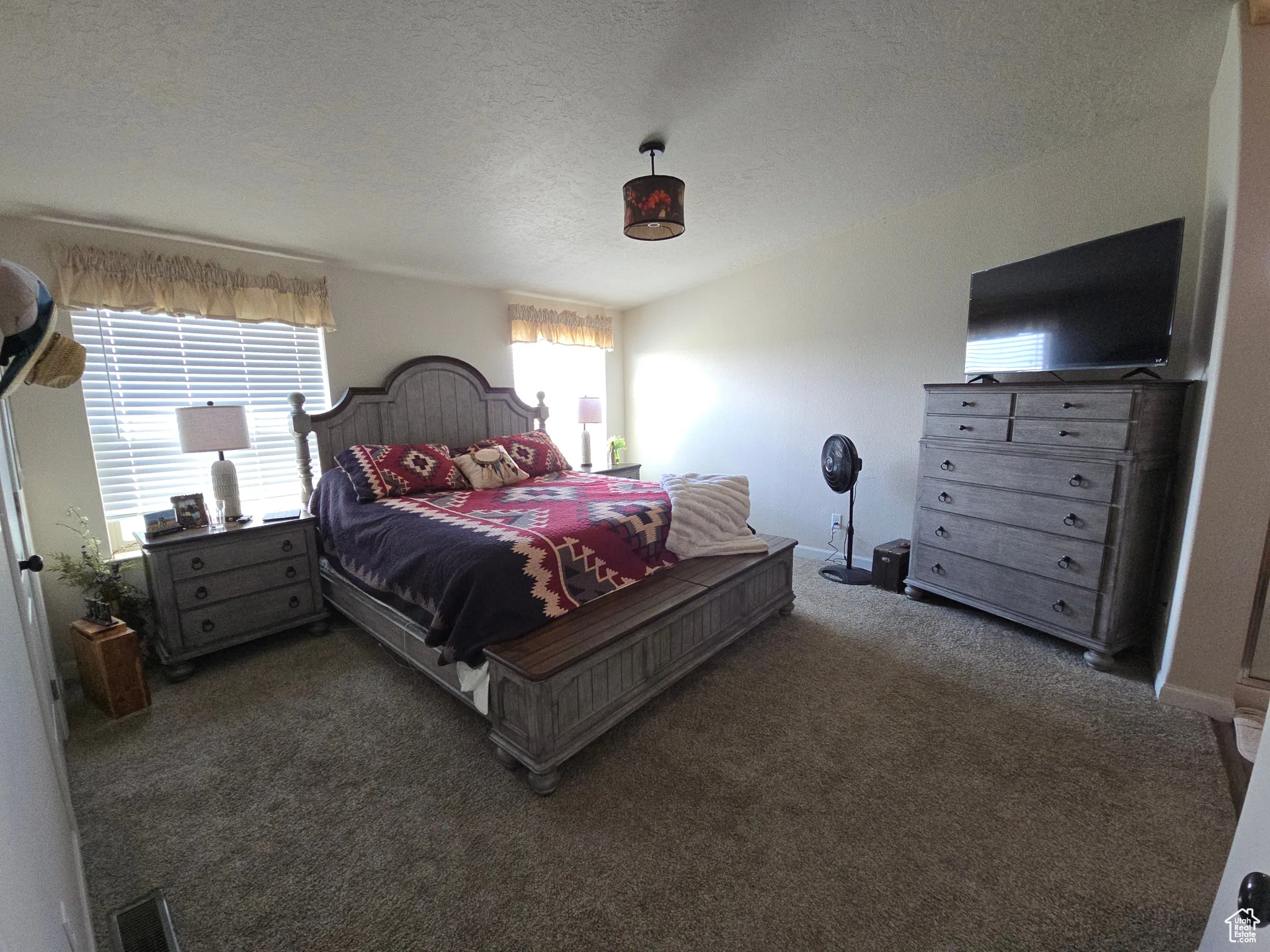 Carpeted bedroom featuring a textured ceiling