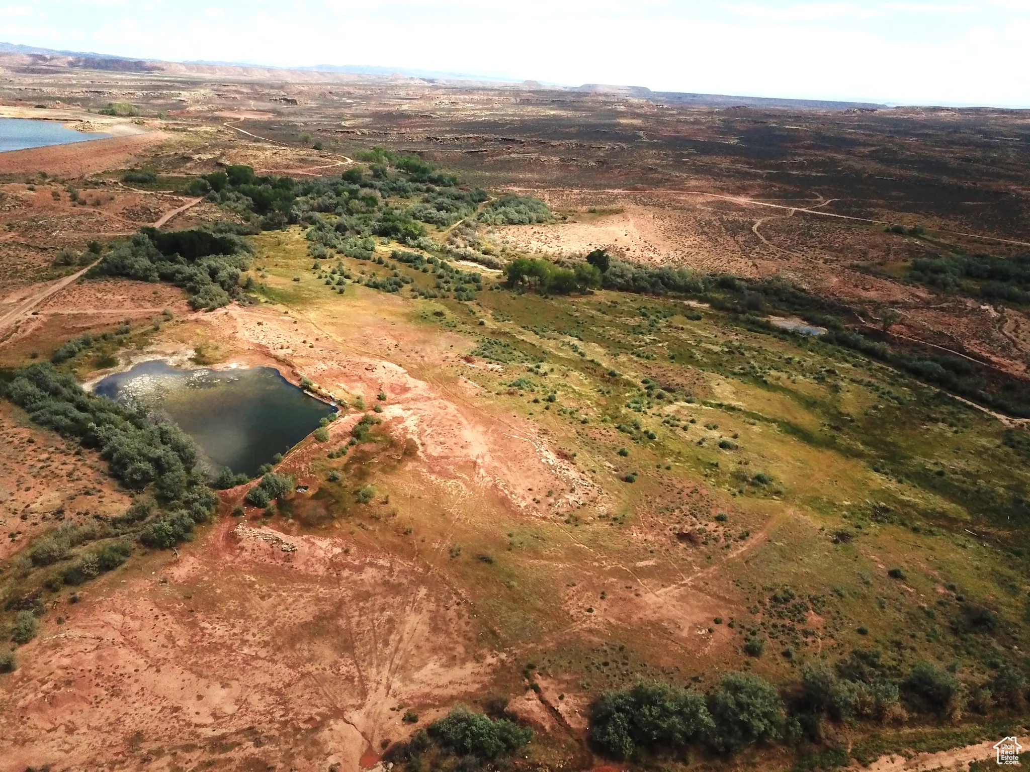 Aerial view of property and surrounding area with a large body of water and rural landscape
