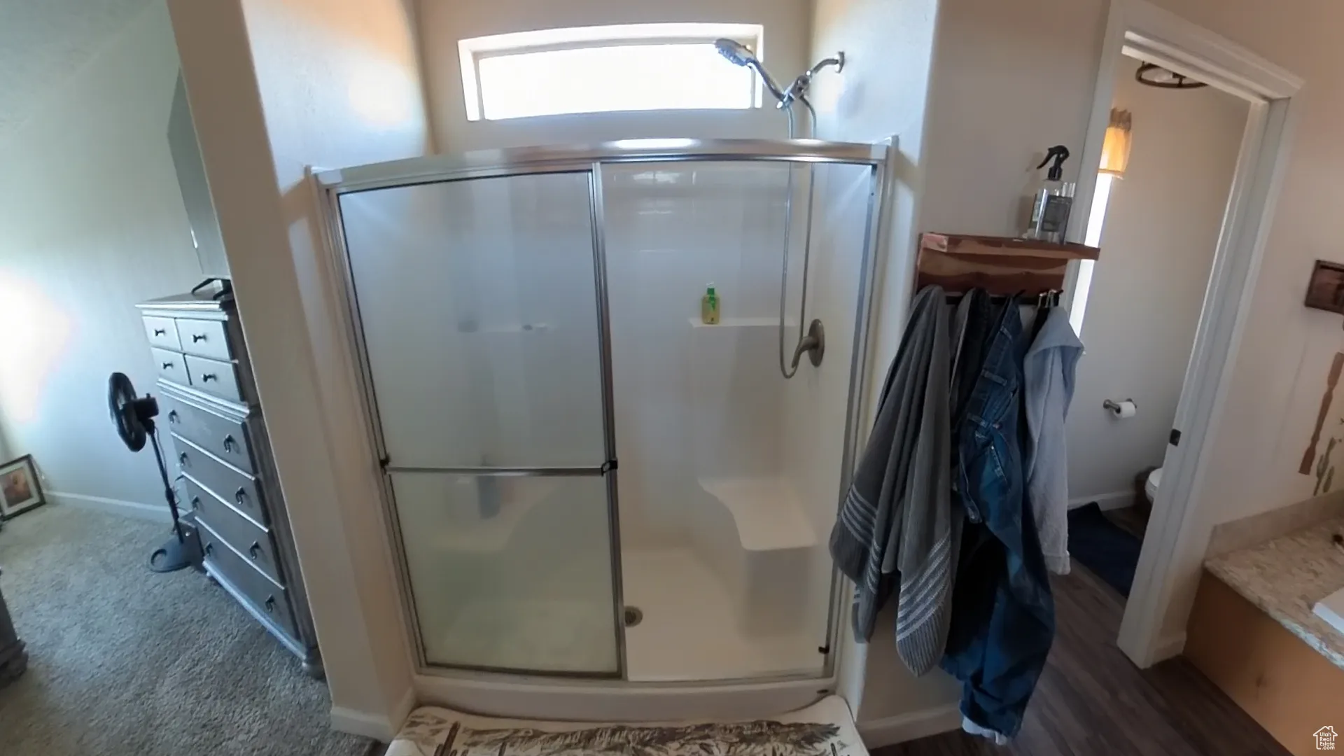 Full bathroom with a stall shower and toilet