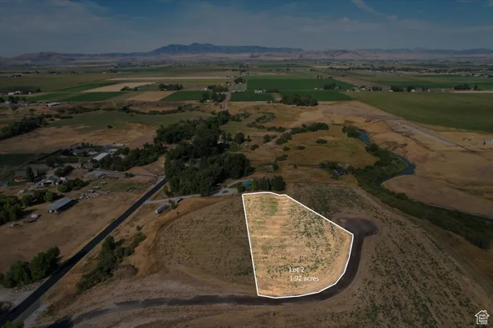 Aerial view of property and surrounding area with mountains, rural landscape, and property boundaries highlighted