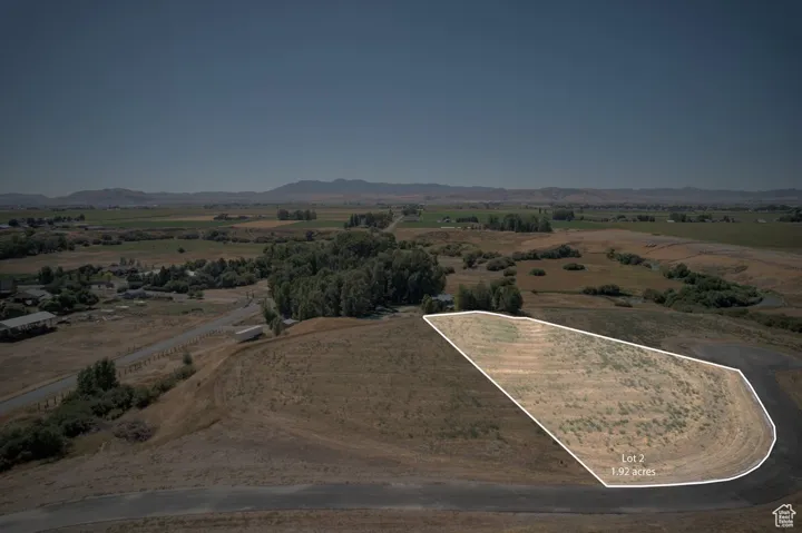Aerial overview of property's location with property parcel outlined and rural landscape