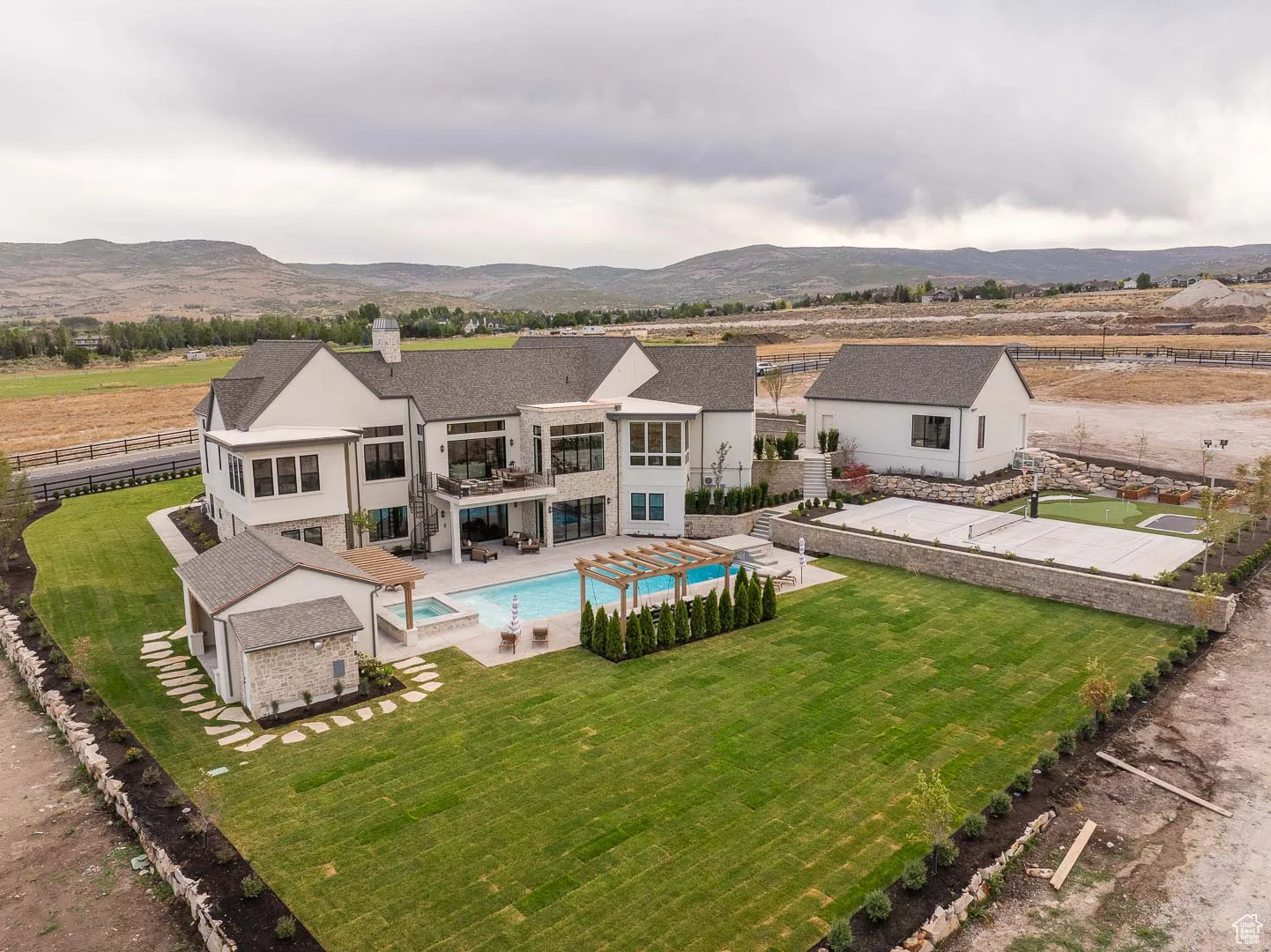Rear view of property featuring a patio, a fenced backyard, a chimney, a pergola, and a mountain view