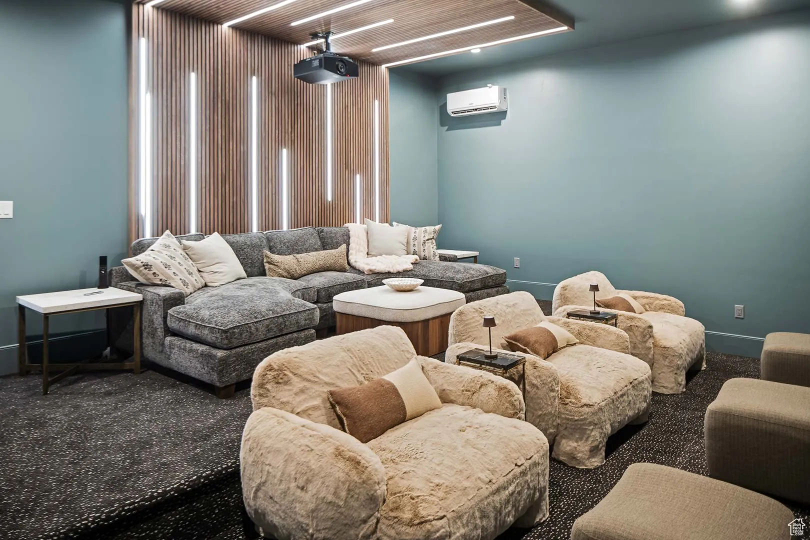 Carpeted home theater room featuring baseboards