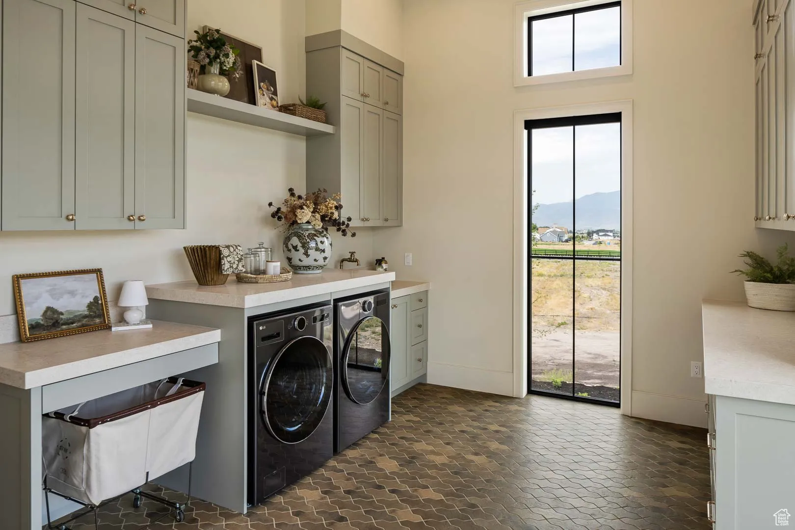 Laundry area with separate washer and dryer and cabinet space