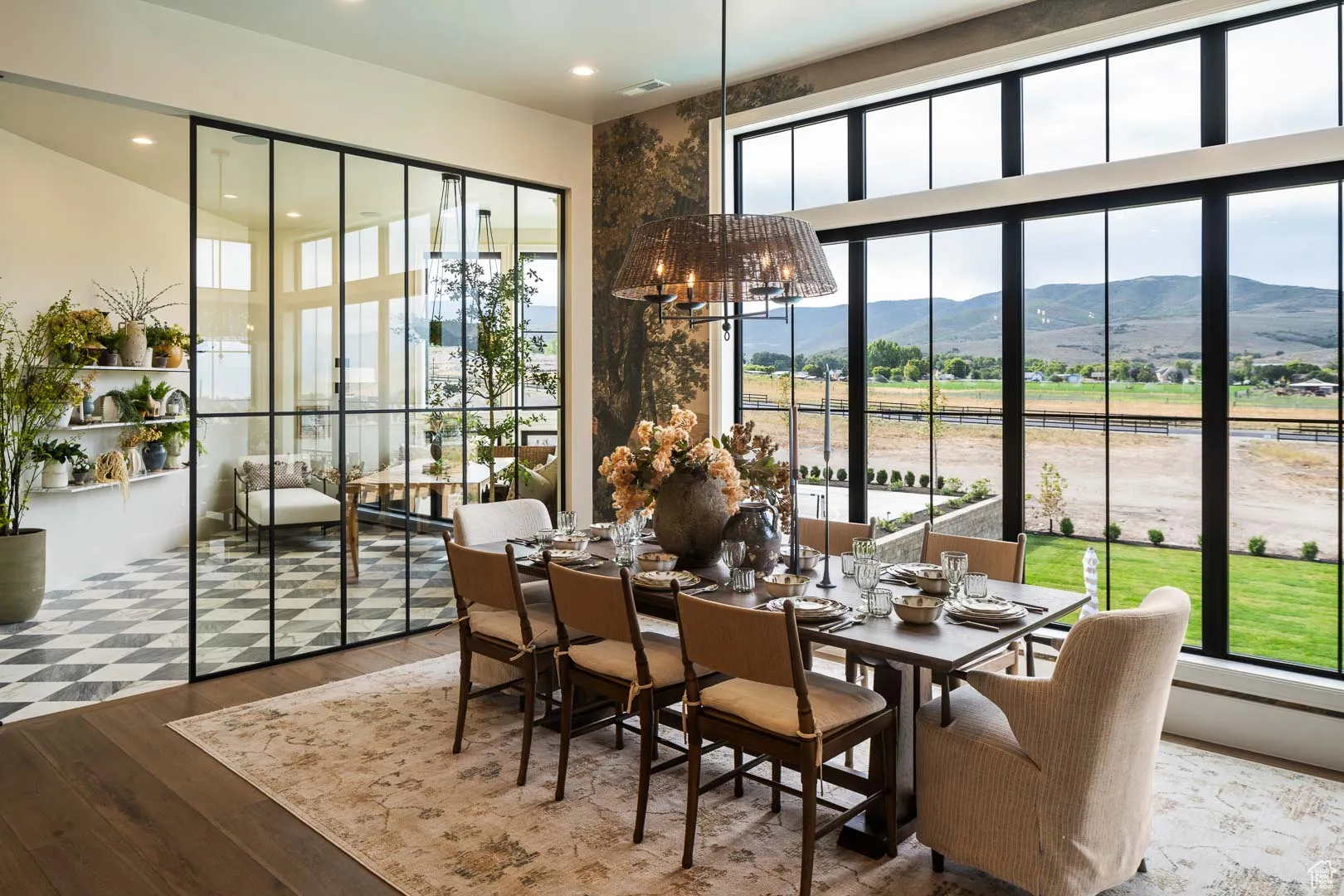 Dining room with a mountain view, a chandelier, wood finished floors, and recessed lighting