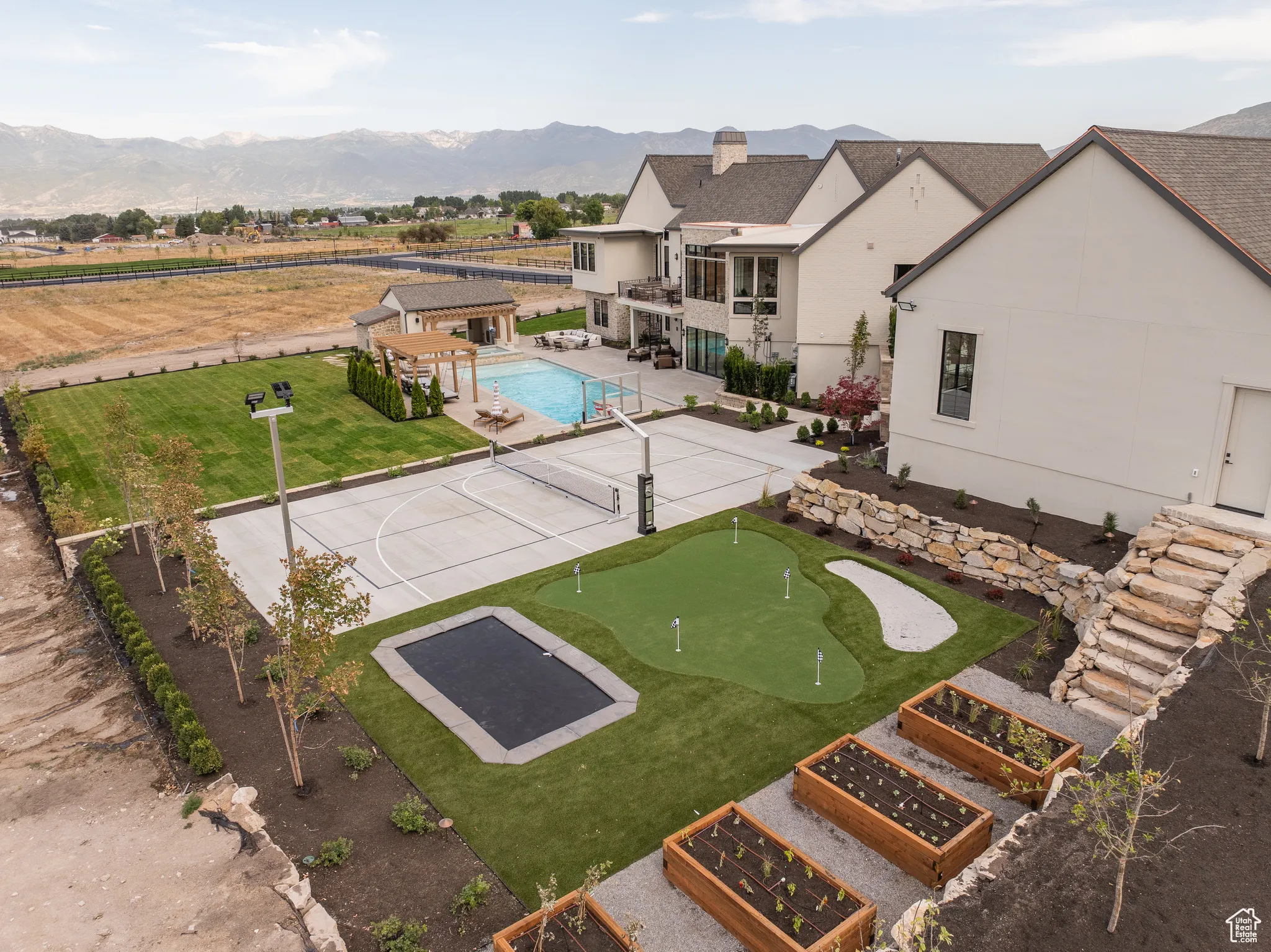 View of home's community with a swimming pool, a patio, a putting green, and a mountain view