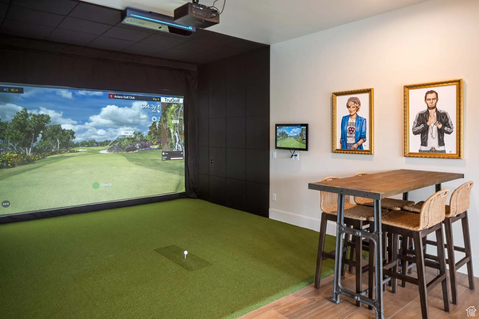 Game room featuring golf simulator and wood finished floors