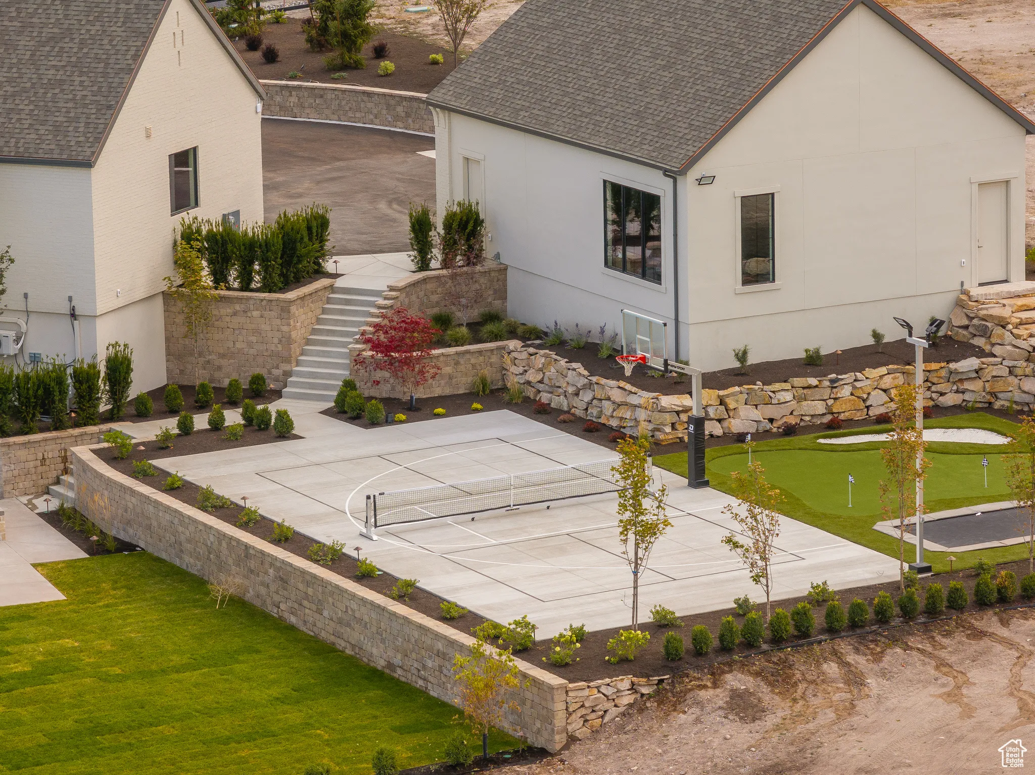 View of basketball court with stairway, a tennis court, and a patio area
