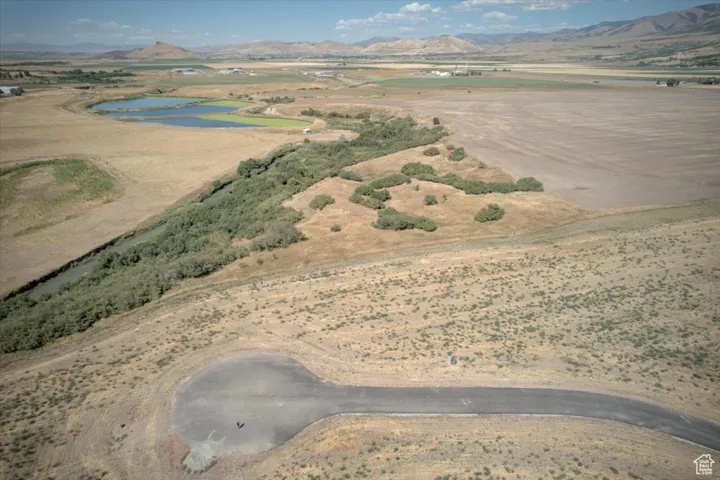 Aerial view of property and surrounding area with a water and mountain view and rural landscape