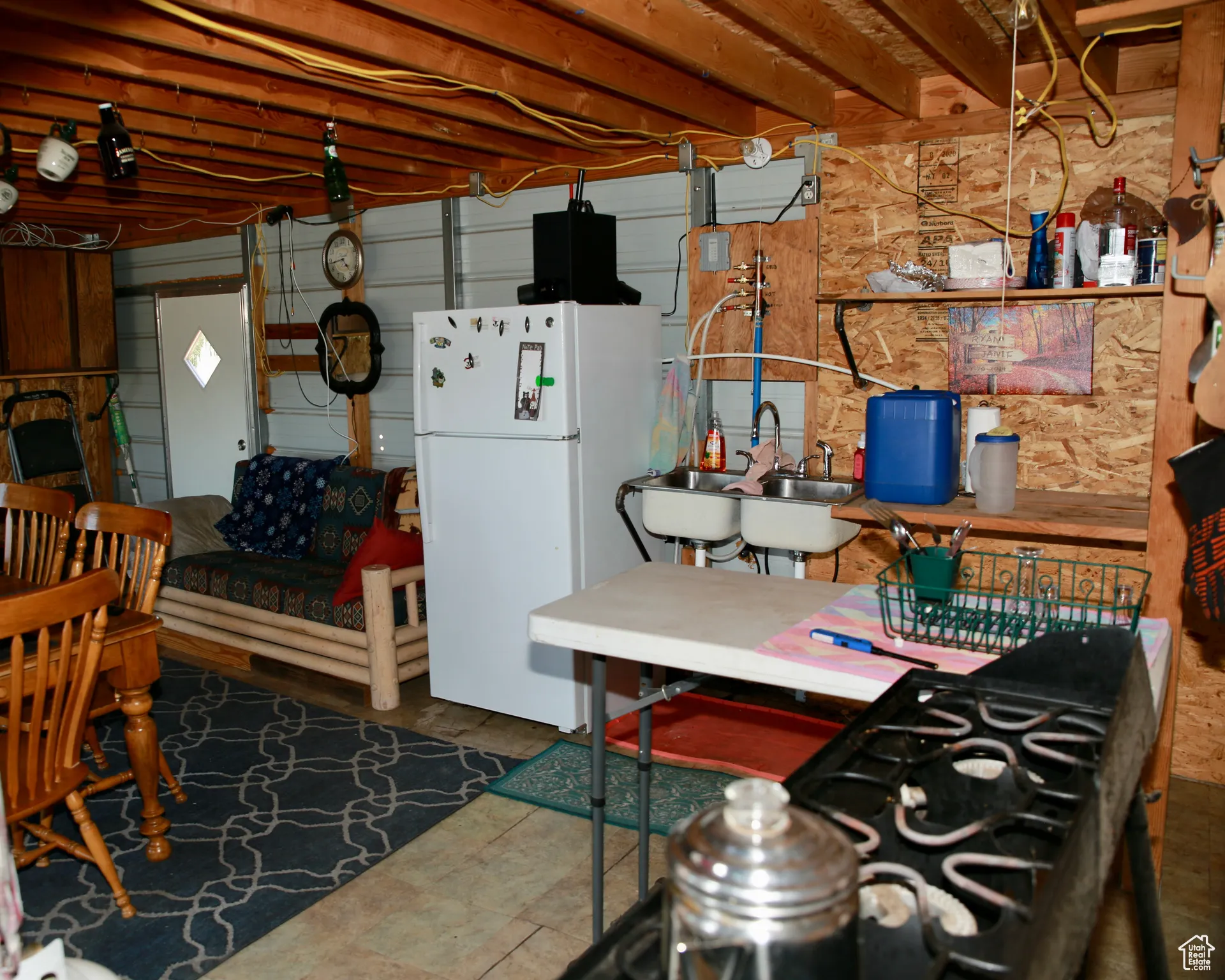 Kitchen with freestanding refrigerator and a sink