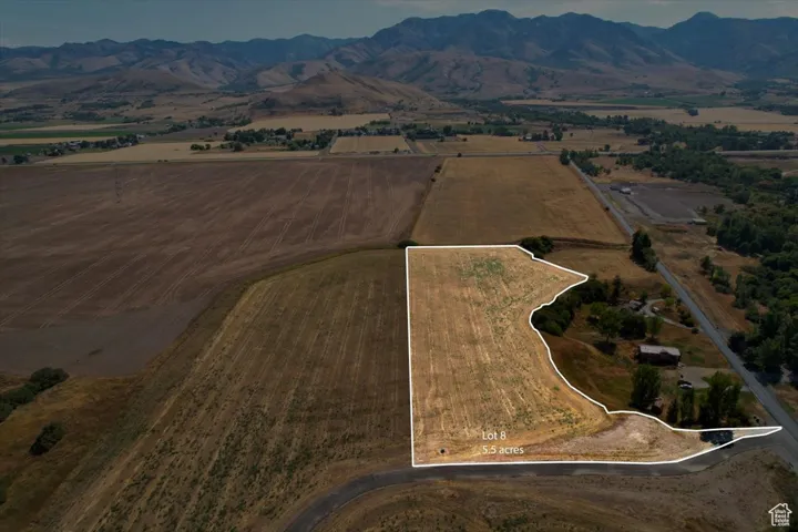 Aerial view of property and surrounding area with property parcel outlined and rural landscape