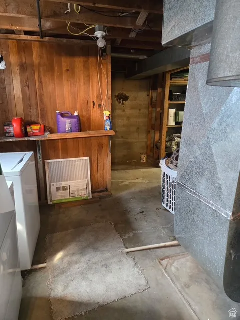 Basement featuring wood walls