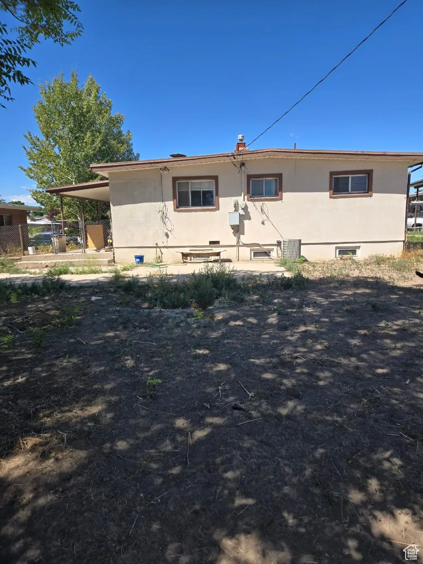 Rear view of property with stucco siding