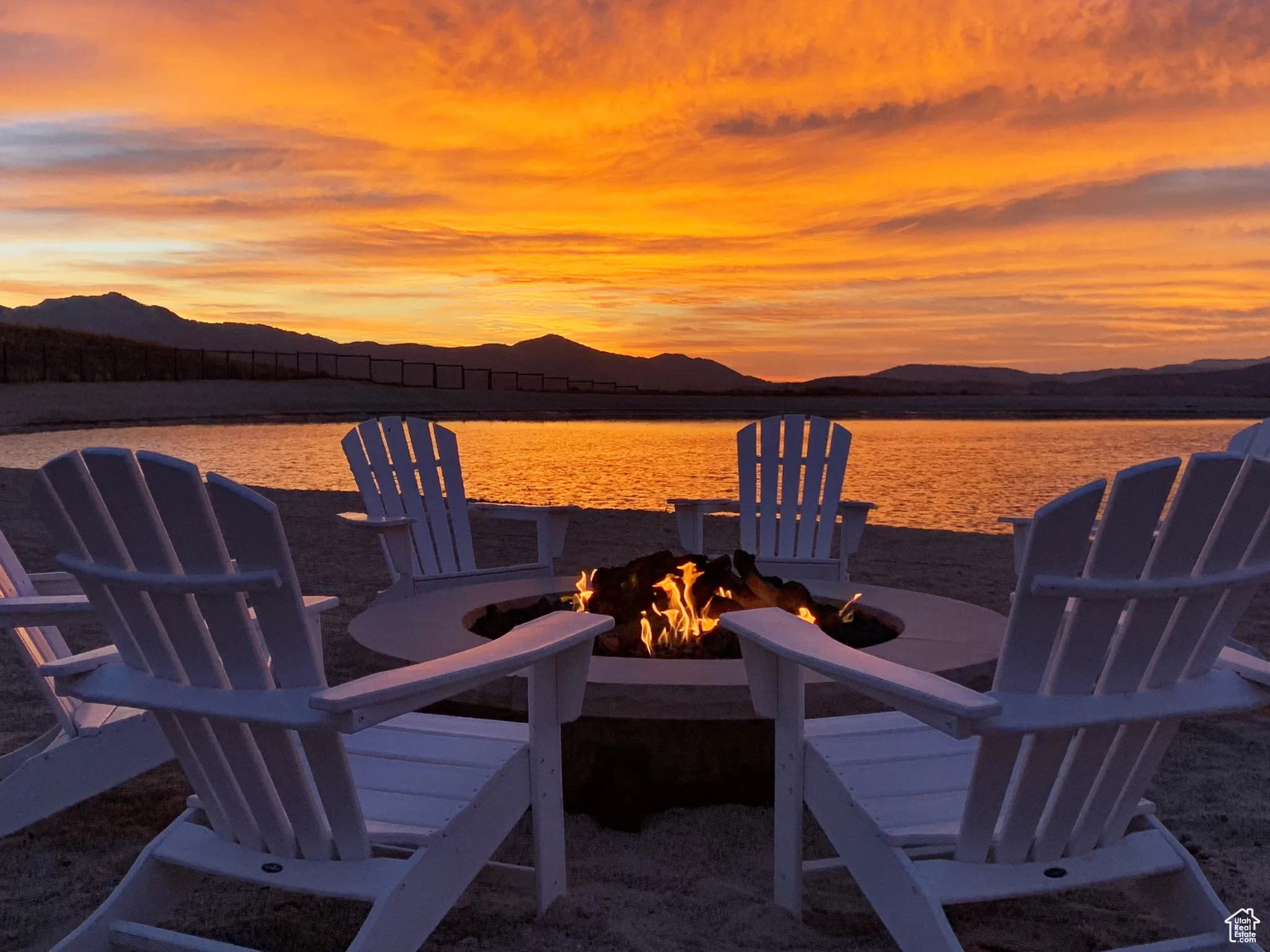 View of patio / terrace with a fire pit and a water and mountain view