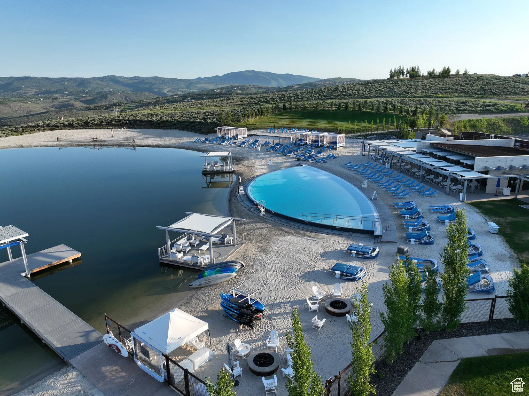 Drone / aerial view of a mountain backdrop and a pool area