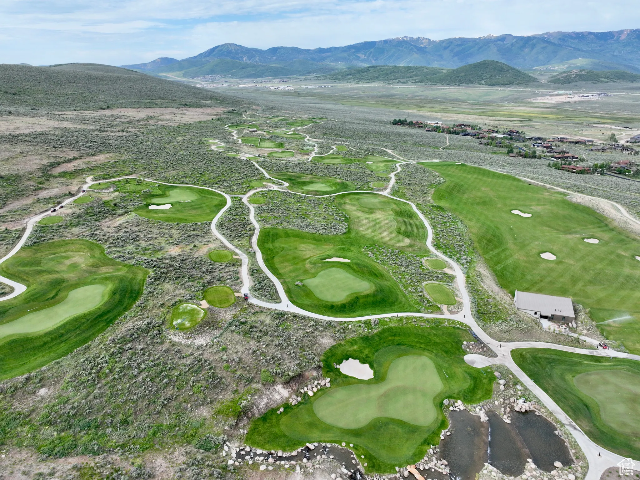 Aerial view of a local golf course and a mountain backdrop