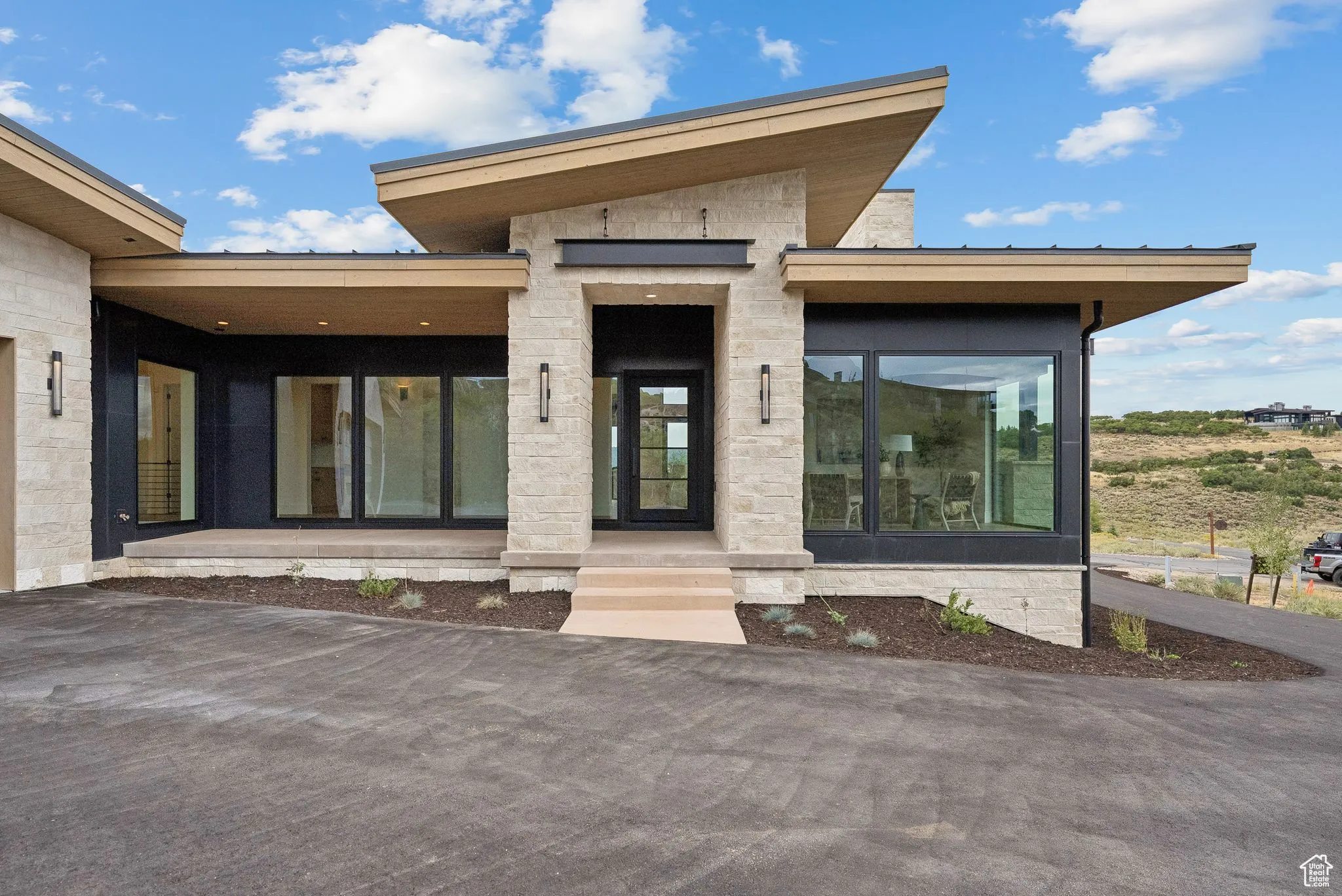 View of exterior entry featuring stone siding
