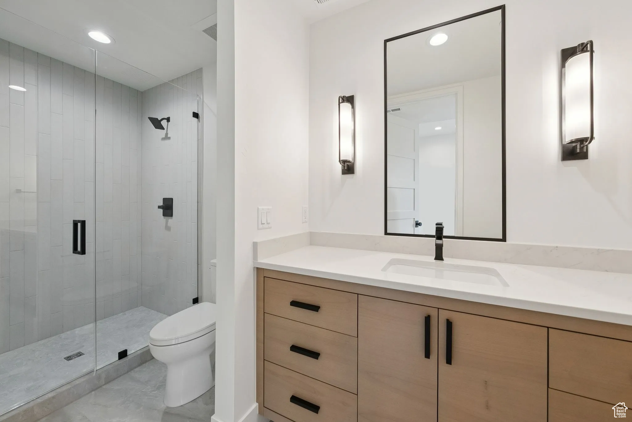 Full bathroom with vanity, a shower stall, and recessed lighting