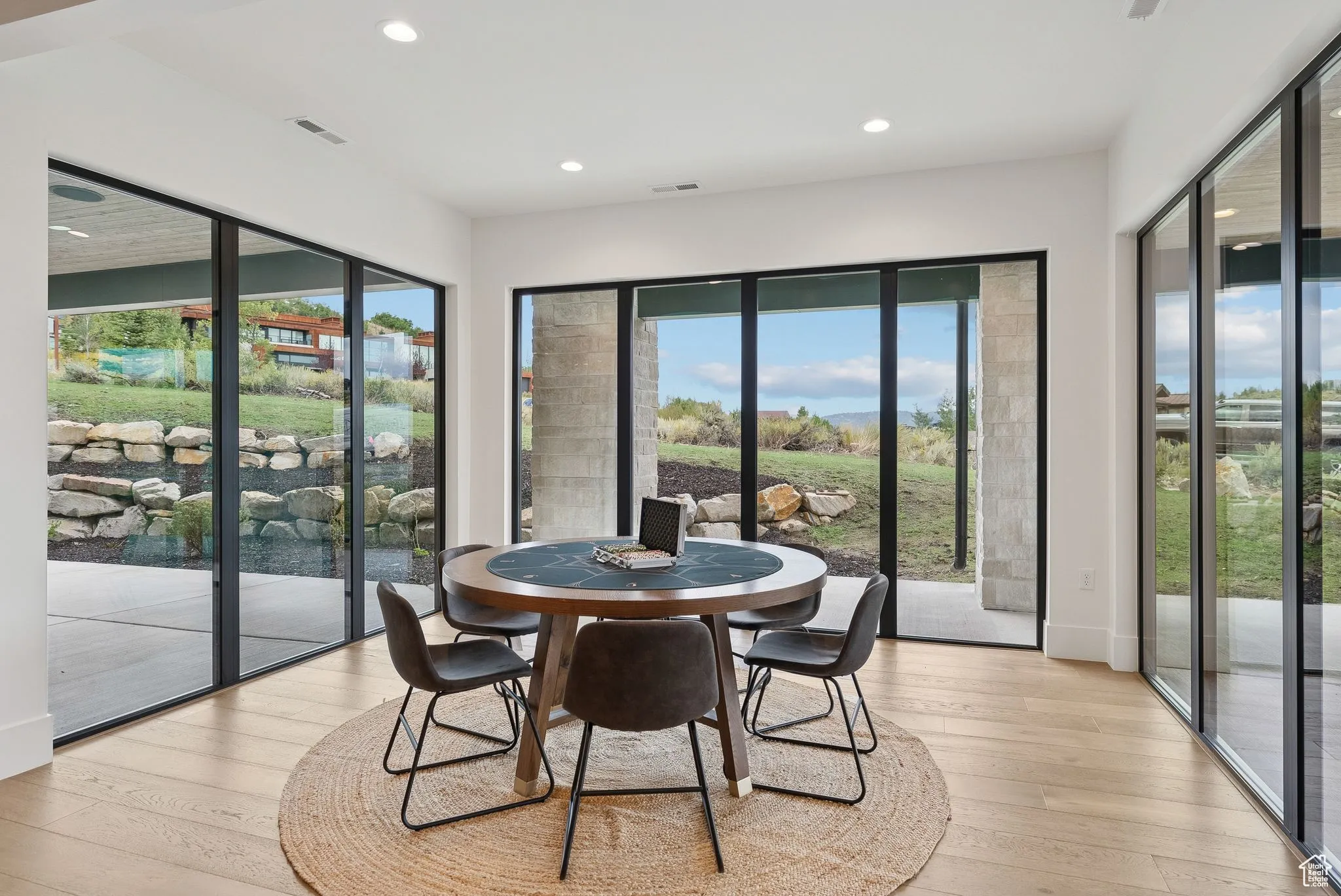 Dining space with light wood-style floors and recessed lighting