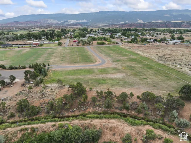 Aerial view of property's location with a mountainous background and rural landscape
